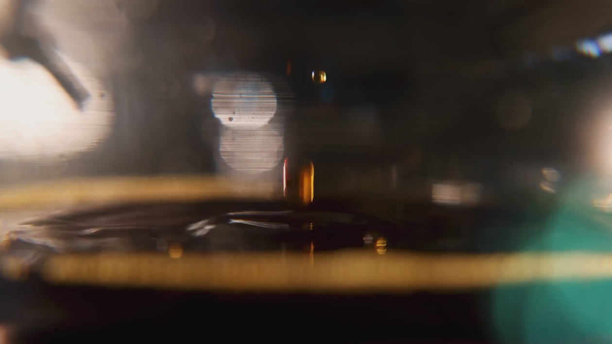 Close up footage of dripping, water pouring, a glass is filled with cold brew, a kettle pouts over an orgami dripper.